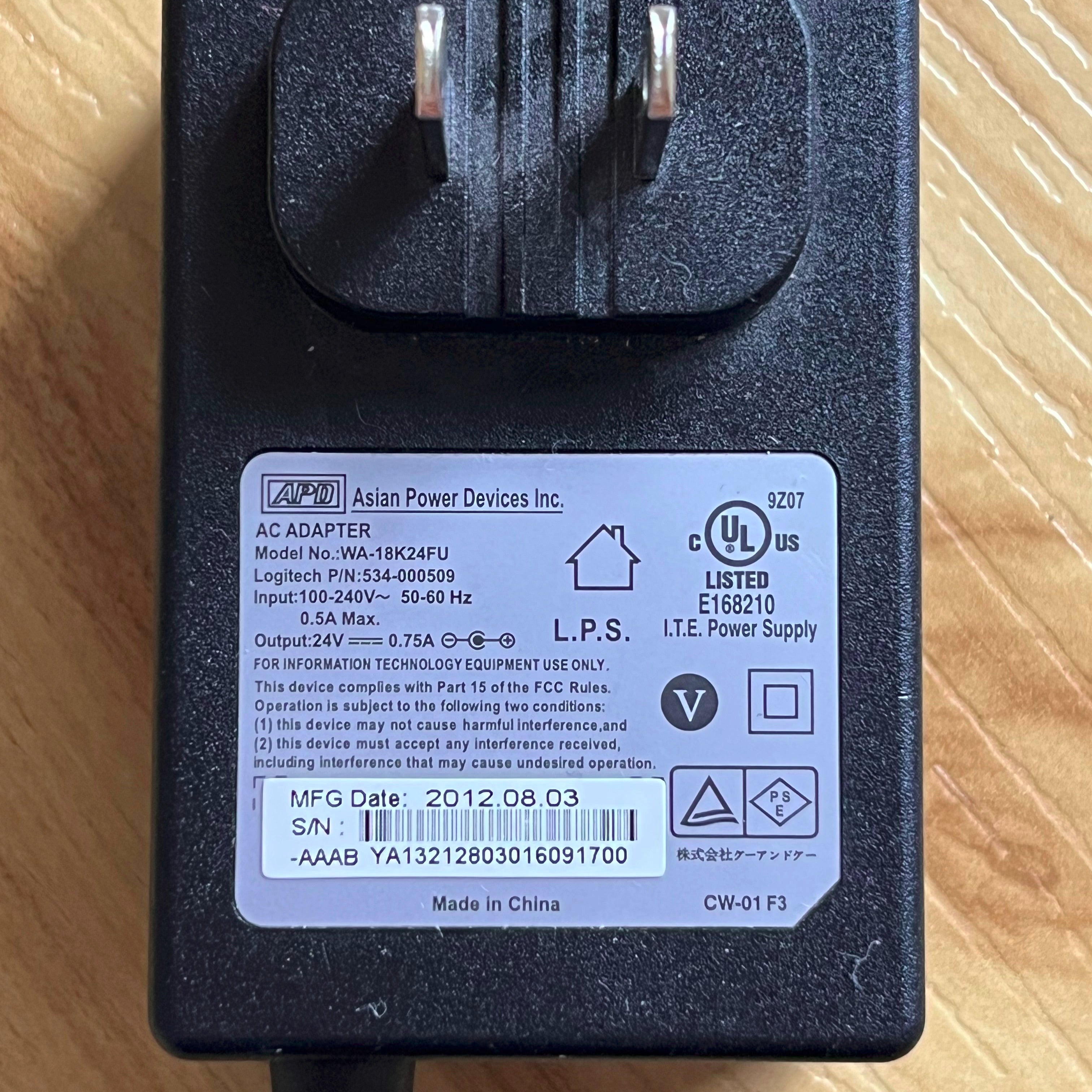 Black power adapter on a wooden surface
