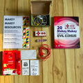 Makey Makey educational kit components on a wooden surface